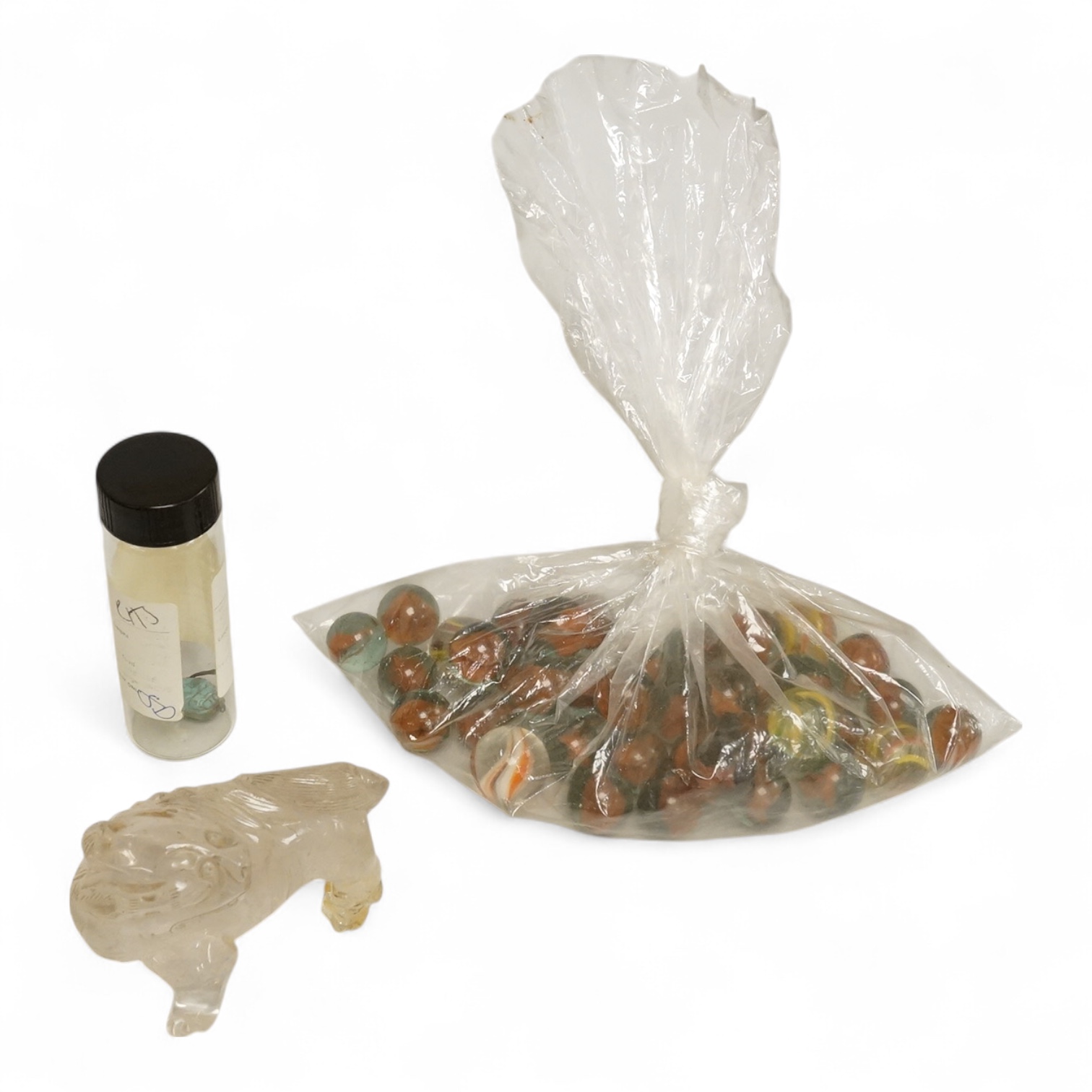 A Chinese carved rock crystal lion, a turquoise bead and a small quantity of marbles, lion 8.5cm wide